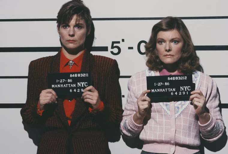 Susan Saint James and Jane Curtain pose for mugshots