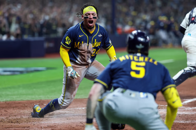 William Contreras #24 of the Milwaukee Brewers reacts after scoring.