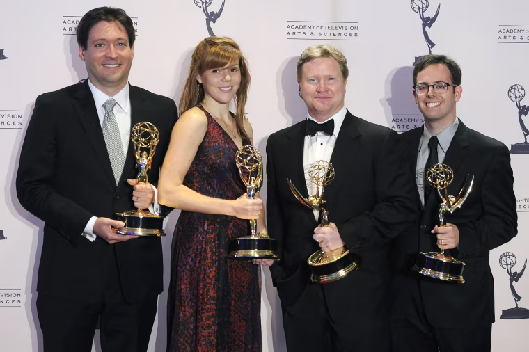 Image: Dan McCoy, Hallie Haglund, Kevin Bleyer and Elliot Kalan, from left to right, pose backstage with the award for outstanding writing for a variety series for "The Daily Show with Jon Stewart".