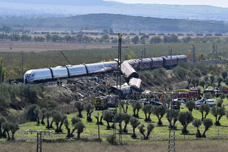Image: Emergency services are seen at the site of a train collision