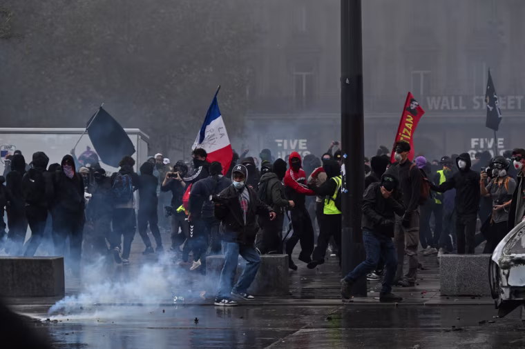 Protesters clash with police during a protest in support of student grievances in Paris on October 17, 2026. 