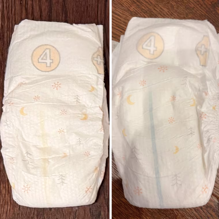 Side-by-side photos of a size 4 diaper with a sun, moon and pine-tree print, showing a yellow wetness line on the left and a blue line on the right.