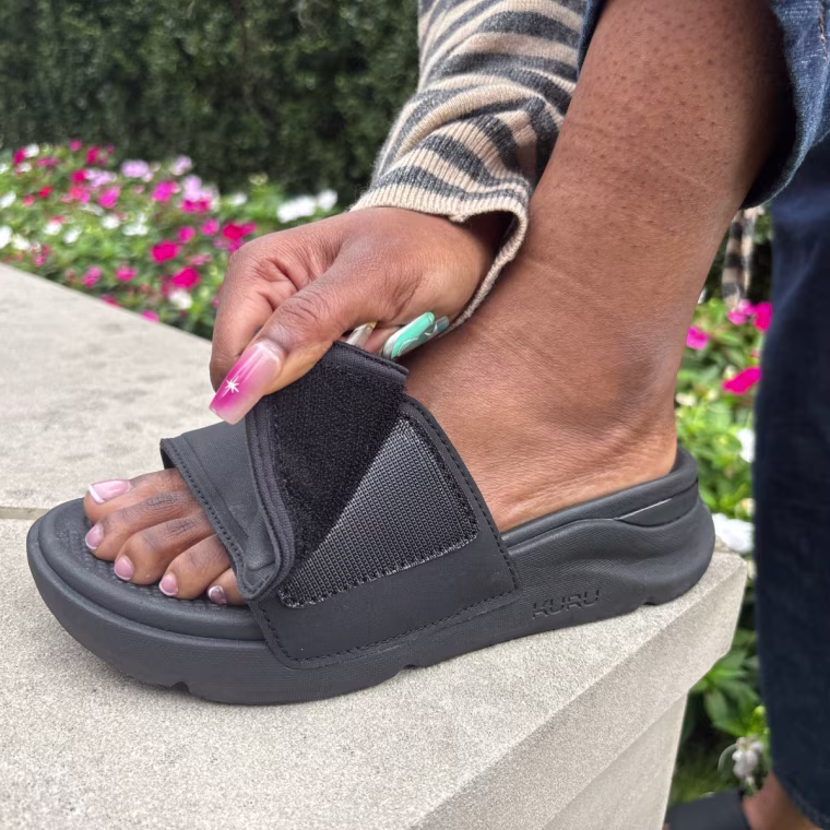 A person adjusting the strap on Kuru’s Moment Recovery Slide.