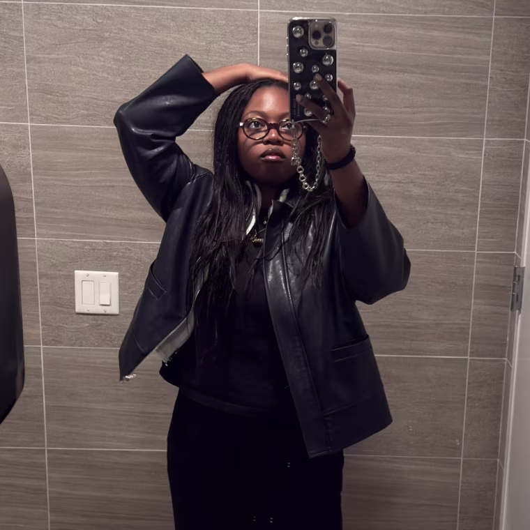 Two mirror selfies of a woman wearing a blue leather jacket.