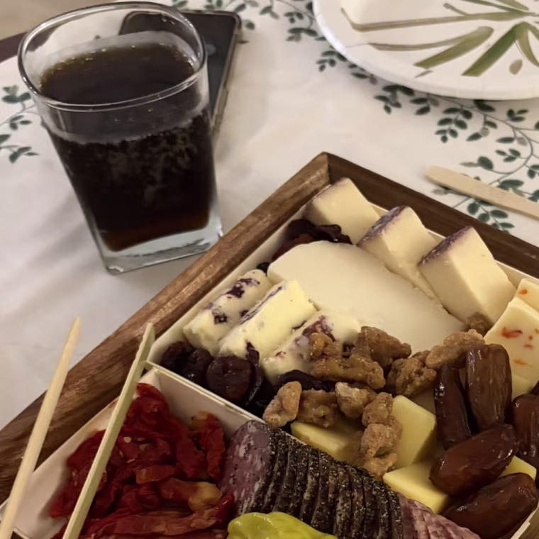 Charcuterie board with meats and cheeses on a dinner table