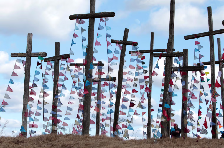A woman prays on a hill with wooden crosses after a procession celebrating Palm Sunday in the town of Oshmiany, 88 miles northwest of Minsk, Belarus, April 1.