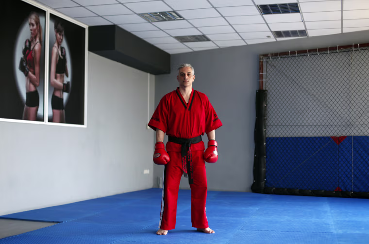 Aris Christodoulou, 39, a martial arts instructor, poses for a picture in his gymnasium in Athens on March 28. When asked how he had been affected by the economic crisis, Christodoulou replied, 'My clients cannot meet the subscription fees and me and my partners aren't taking a wage'.
