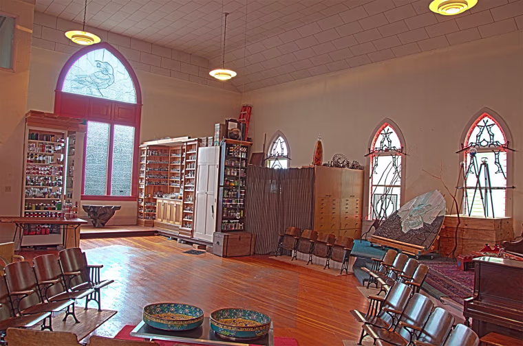 The great room of the house, once the church sanctuary, is dominated by a large cast glass window created by artist David Chatt.