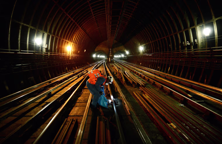 A cleaner, known as a fluffer, inspects the train tracks on the Victoria Line near Highbury and Islington station in London March 30, 2012. Transport for London (TfL), which is responsible for the majority of London's transport system, including the London Underground, expects to see an additional 500,000 passengers on the tube during the Olympics, a number that has seen many voice their concerns over whether the system can cope with the influx.