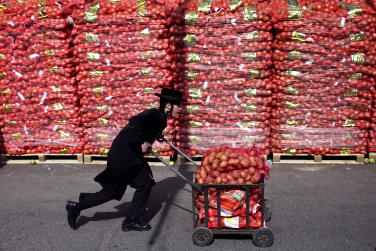 An ultra-Orthodox Jewish man pushes a cart full of potatoes in the Mea Shearim neighborhood of Jerusalem, Israel, on April 3. The potatoes are provided by charity organizations for people in need ahead of the Jewish holiday of Passover, which falls on the evening of April 6. Passover, one of Judiasm's most important holidays, commemorates the Jewish exodus from ancient Egypt and their wandering in the desert on their way to Israel, and is celebrated with the 'Seder,' or Passover dinner.