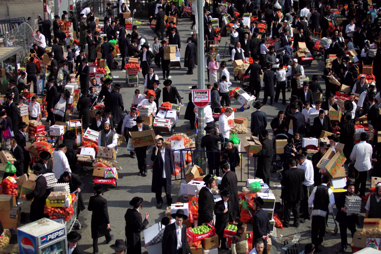 Ultra-Orthodox Jewish men gather for food distribution in the Mea Shearim neighborhood of Jerusalem, Israel, April 3.