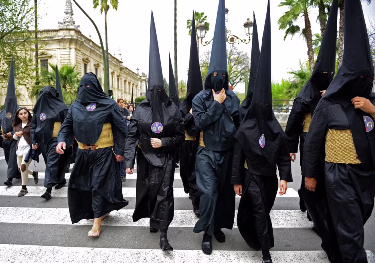 Penitents walk to their church during Holy Week in Seville in southern Spain on April 3. Christians around the world mark the Holy Week of Easter in celebration of the crucifixion and resurrection of Jesus Christ.