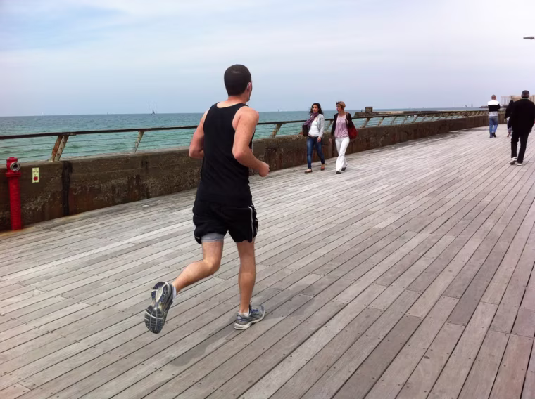 A runner enjoys Tel Aviv beach's six-mile long promenade that runs from Old Jaffe to Sde Dov airport.