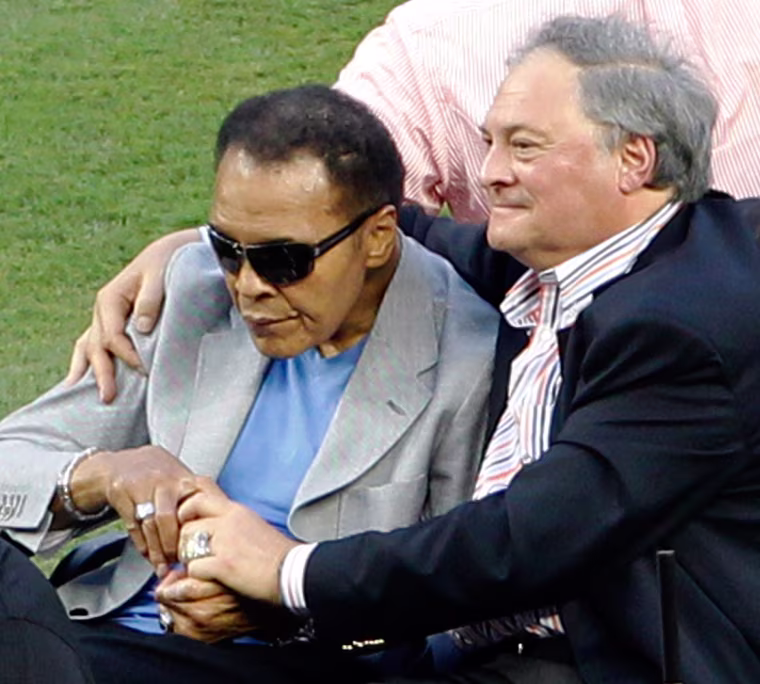 Muhammad Ali, left, rides onto the field with Miami Marlins owner Jeffrey Loria during Opening Day events.