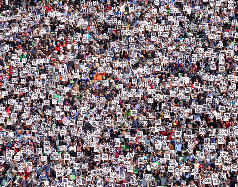 Udinese's supporters hold placards written '25' in memory of late player Piermario Morosini prior the Italian Serie A football match between Udinese and Inter Milan on April 25, at Friuli Stadium in Udine.