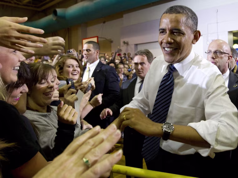 President Barack Obama greets people as he arrives in an overflow before he speaks at the University of Iowa, Wednesday, April 25, 2012, in Iowa City, Iowa.