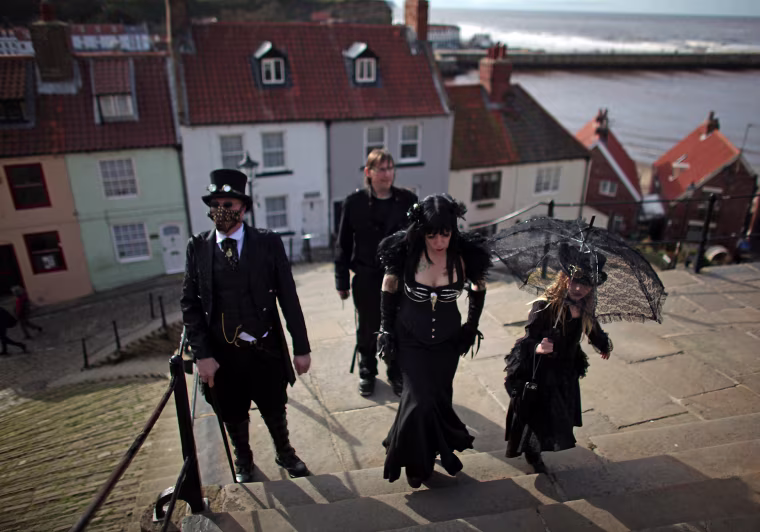 Goths and Steampunks walk through Whitby during Whitby Goth Weekend.