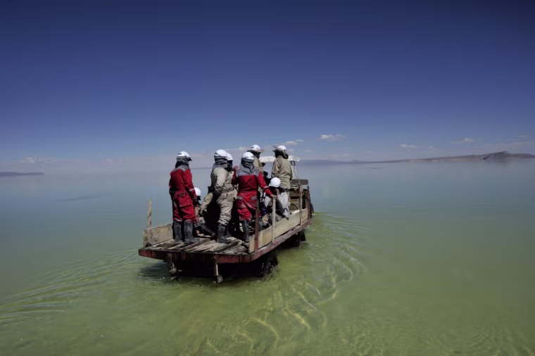 Due to heavy rainfall, much of the Salar de Uyuni is still covered with water. A tractor brings the workers to the experimental evaporation plant.