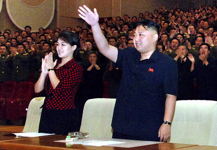 This undated photo released by North Korea's official Korean Central News Agency (KCNA) on July 27, 2012 shows North Korean leader Kim Jong-Un and his wife Ri Sol-Ju reacting after watching a performance by members of the Korean People's Internal Security Forces (KPISF) at Ponghwa Art Theatre in Pyongyang.