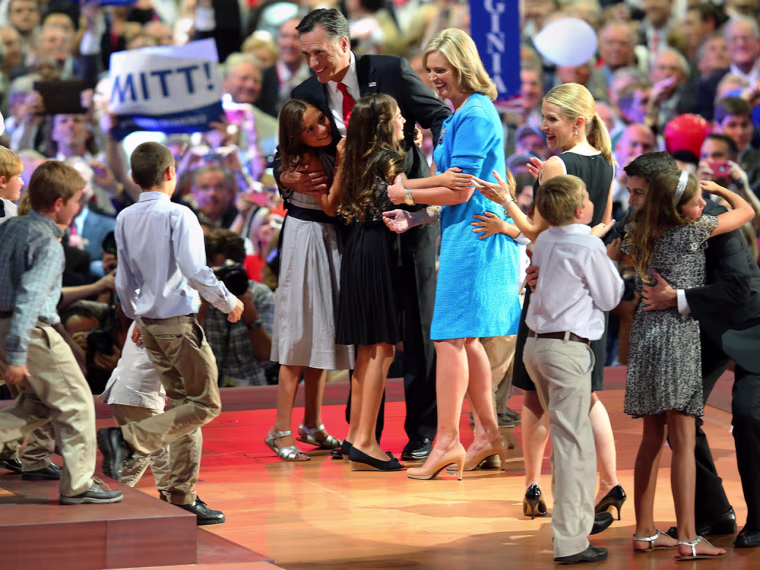 Mitt Romney stands with his wife, Ann Romney, and family as Paul Ryan and his wife, Janna Ryan, stand with their family on stage as balloons drop during the final night of Republican National Convention in Tampa.