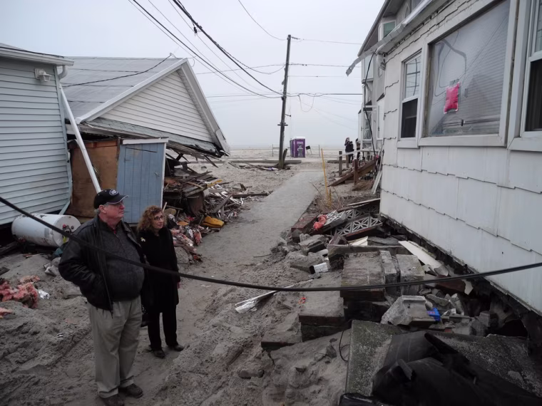 Madeline DiLorenzo-Coscia, 63, and her husband, Jerome Hoffman, 62, look at their 'little frame shack' in Breezy Point on Dec. 8.