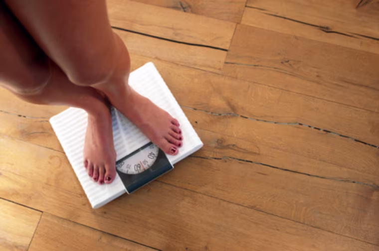Woman standing on weighing scales, elevated view Getty Images stock, msnbc stock photography, Control, Aspirations, Accuracy, Horizontal, Indoors, Low Section, Close-up, High Angle View, Front View, Human Foot, Caucasian Appearance, Barefoot, Weight Scale, Naked, Standing, One Person, Body Conscious, Color Image, Nail Polish, Toenail, Bathroom Scale, Hardwood Floor, Dieting, Series, One Woman Only, Wellbeing, Photography, Adults Only