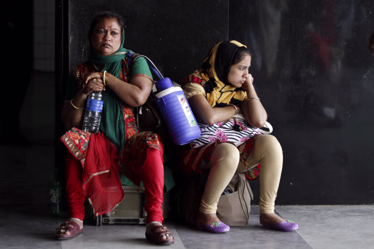 Stranded railway passengers wait on a platform during a day-long strike in Kolkata, India, Tuesday, Feb. 28, 2012. Shops and banks were closed, factories shuttered and traffic sparse in major cities across India during an industrial strike Tuesday called by trade unions against the government. Eleven major trade unions called for the strike to protest against rampant inflation. (AP Photo/Bikas Das)