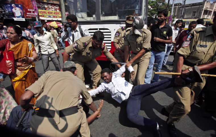 Indian police officers detain a member of a left-wing party during a protest in support of a general strike in Hyderabad, India, Tuesday, Feb. 28, 2012. Shops and banks were closed, factories shuttered and traffic sparse in major cities across India during an industrial strike Tuesday called by trade unions against the government. Eleven major trade unions called for the strike to protest against rampant inflation. (AP Photo/Mahesh Kumar A.)