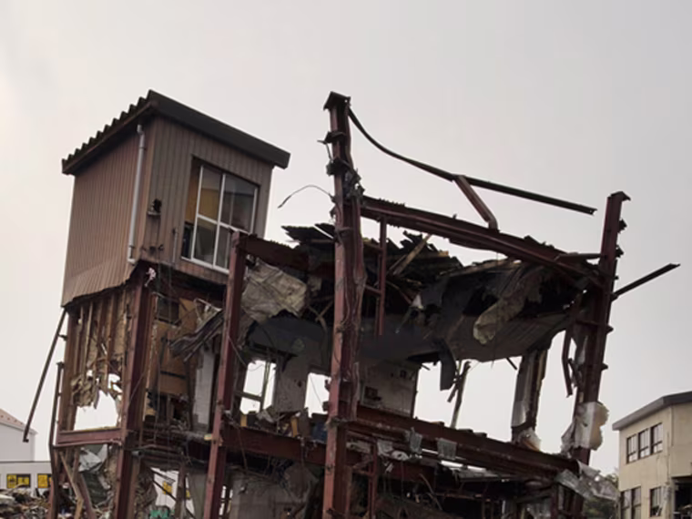 In this combo of two photos, a damaged house stands in a flooded residential area March 20, 2011, left, and the sun shines over the same area June 3, 2011 in Kesennuma, Miyagi Prefecture, northeastern Japan. Japan marks three month since the March 11 earthquake and tsunami Saturday, June 11, 2011. (AP Photo/Kyodo News) JAPAN OUT, MANDATORY CREDIT, NO LICENSING IN CHINA, HONG KONG, JAPAN, SOUTH KOREA AND FRANCE