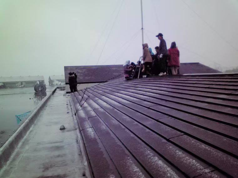 ATTENTION EDITORS: PICTURE 9 OF 15 FOR PACKAGE 'TSUNAMI SURVIVORS REUNITED' - Children and teachers from Ishinomaki Mizuho No.2 kindergarten take shelter on the roof of their school during the tsunami following Japan's 9.0 magnitude earthquake in Ishinomaki, northern Japan in this photo taken by head teacher Hiroaki Tsuda with his mobile phone on March 11, 2011. Yuko Sugimoto's son Raito was among the children that survived the disaster as they to on the rooftop and stayed through the night until the Coast Guard rescued them the following morning. Picture taken March 11, 2011. Mandatory Credit REUTERS/Ishinomaki Mizuho Kindergarten head Hiroaki Tsuda/Handout (DISASTER ANNIVERSARY ENVIRONMENT) FOR EDITORIAL USE ONLY. NOT FOR SALE FOR MARKETING OR ADVERTISING CAMPAIGNS. THIS IMAGE HAS BEEN SUPPLIED BY A THIRD PARTY. IT IS DISTRIBUTED, EXACTLY AS RECEIVED BY REUTERS, AS A SERVICE TO CLIENTS. MANDATORY CREDIT