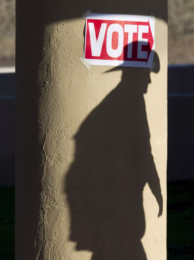 A shadow of a man wearing a cowboy hat falls on a pillar as he enters the polling place at Wickenburg Community Center February 28, 2012 in Wickenburg, Arizona. Republican voters cast ballots for the presidential nominee of their choice in Arizona and Michigan, where Mitt Romney is favored to win and break the momentum of Christian conservative rival Rick Santorum. The latest polls show Republican candidate Mitt Romney has opened up a double-digit lead in Arizona, where a significant percentage of the population shares his Mormon faith and where he likely benefited from large numbers of early voters. AFP PHOTO/DON EMMERT (Photo credit should read DON EMMERT/AFP/Getty Images)