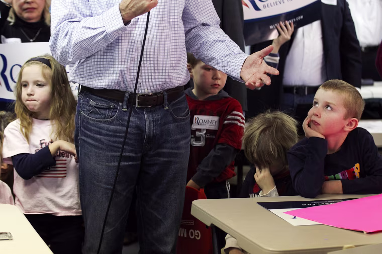LIVONIA, MI - FEBRUARY 28: Children watch as Republican presidential candidate and former Massachussetts Gov. Mitt Romney speaks during a press availability following a visit to his Michigan campaign headquarters on February 28, 2012 in Livonia, Michigan. Romney visted his Michigan campaign headquarters an primary day as Michigan residents go to the polls to vote for their choice in the Republican presidential race. (Photo by Justin Sullivan/Getty Images) *** BESTPIX ***