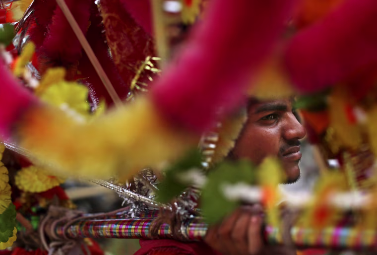 A Kanwaria walks with others in a pilgrimage in New Delhi.