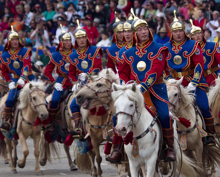 Mongolian honor guards on horseback perform during the Naadam Festival opening ceremony in Ulan Bator, Mongolia Wednesday, on July 11.