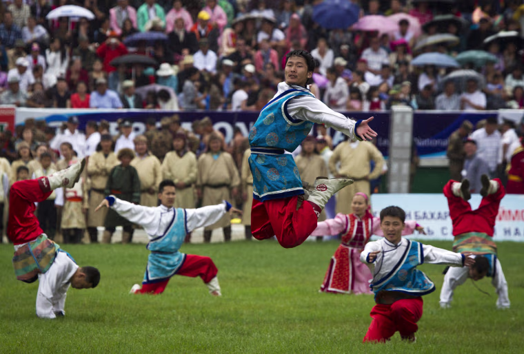 Mongolians in traditional costume perform during the Naadam Festival opening ceremony in Ulan Bator, Mongolia, Wednesday, on July 11.