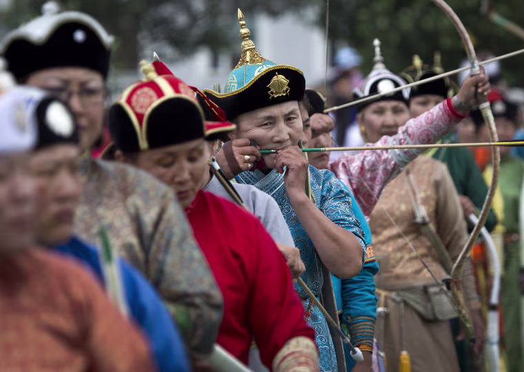 Mongolian women take part in an archery competition during the Naadam Festival in Ulan Bator, Mongolia Wednesday, on July 11.