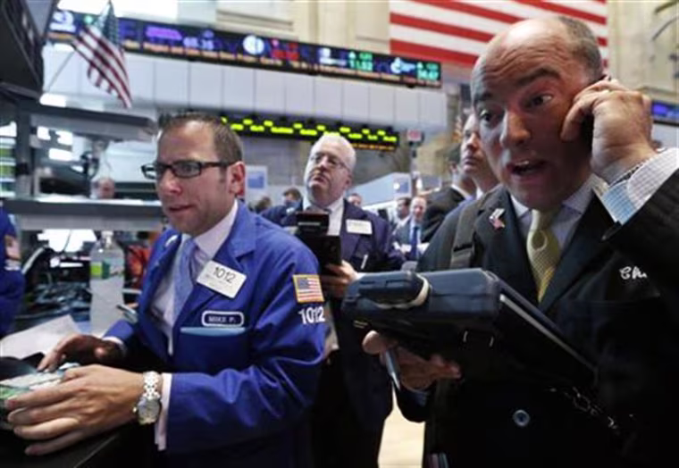 Traders work on the floor of the New York Stock Exchange.