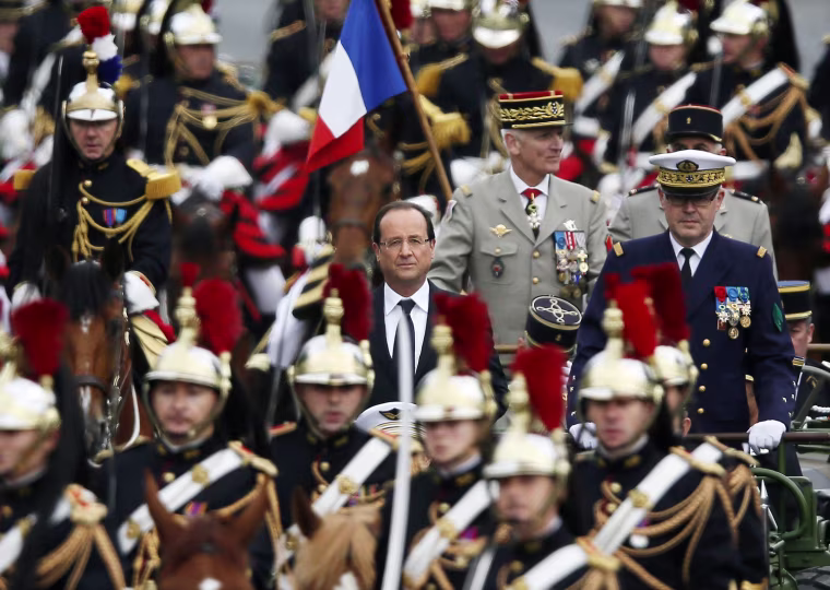 French President Francois Hollande arrives by car with French Army Chief of Staff Admiral Edouard Guillaud, right, at the Place de la Concorde to attend the Bastille Day military parade in Paris, France, on July 14. The Bastille Day, the French National Day, is held annually on 14 July to commemorate the storming of the Bastille fortress in 1789.