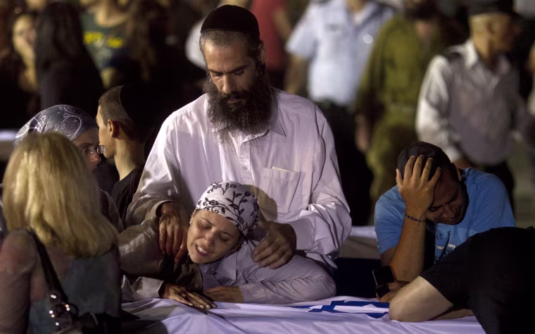 Relatives mourn five Israelis killed during an explosion on a tour bus in Burgas, Bulgaria, after their arrival at the Ben Gurion International Airport near Tel Aviv on July 20, 2012.