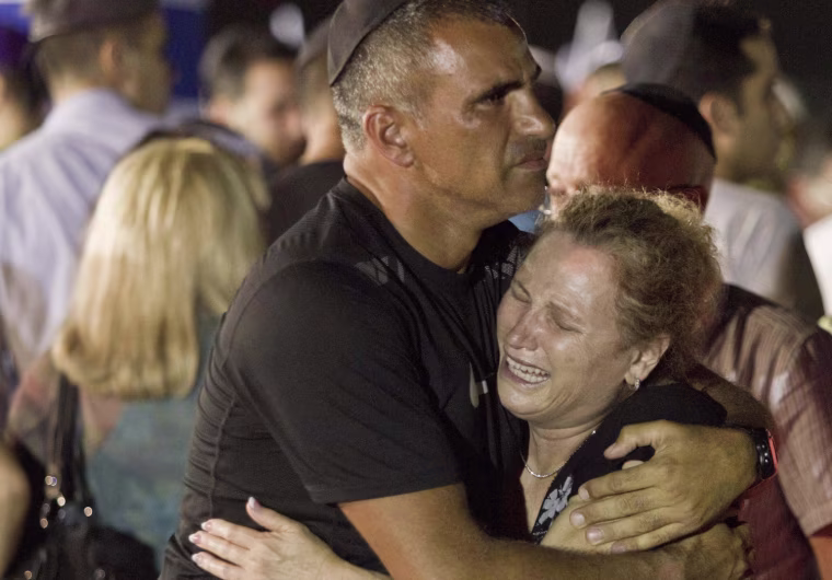 An Israeli family cries during a military ceremony for victims killed in an attack in Bulgaria, at the Ben Gurion International Airport near Tel Aviv on July 20, 2012.