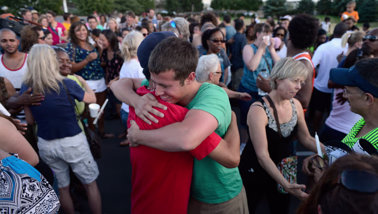 Mourners at a vigil near theater where 12 people were killed July 20, 2012 in Aurora, Colo.