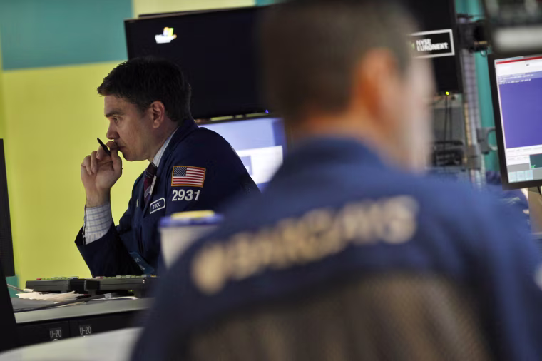 Traders work on the floor of the New York Stock Exchange Monday.