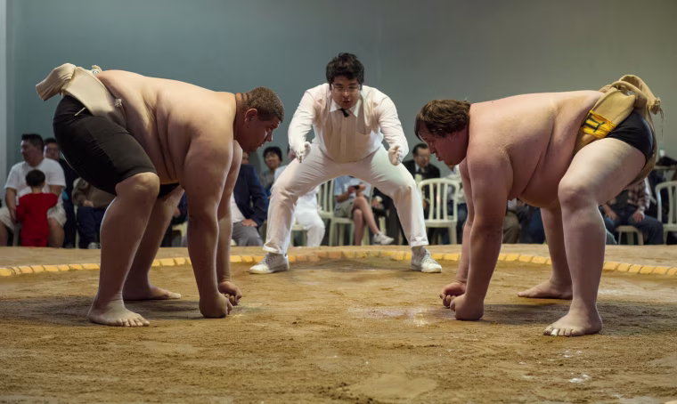 Juan Castro, left, a heavy weight champion from Venezuela, and Mario Frabetti, an open champion from Brazil, face each other before a match during the Sumo wrestling South American Championship in Sao Paulo, Brazil on July 22, 2012.