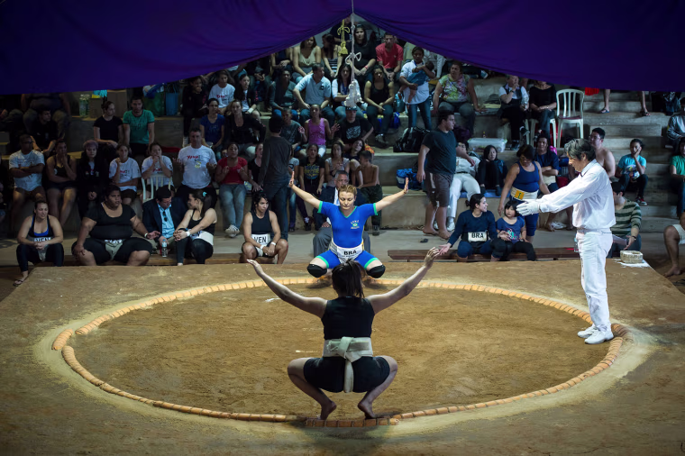 Luciana Watanabe (top) of Brazil, a light weight female champion, and her opponent perform a pre-match ritual during the Sumo wrestling South American Championship on July 22.