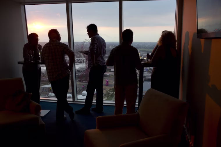 Workers and corporate guests watch the opening ceremonies from the 38th floor of Stratford Halo, a 43 story-housing tower still under development in Stratford, London, only a mile from Olympic Park.