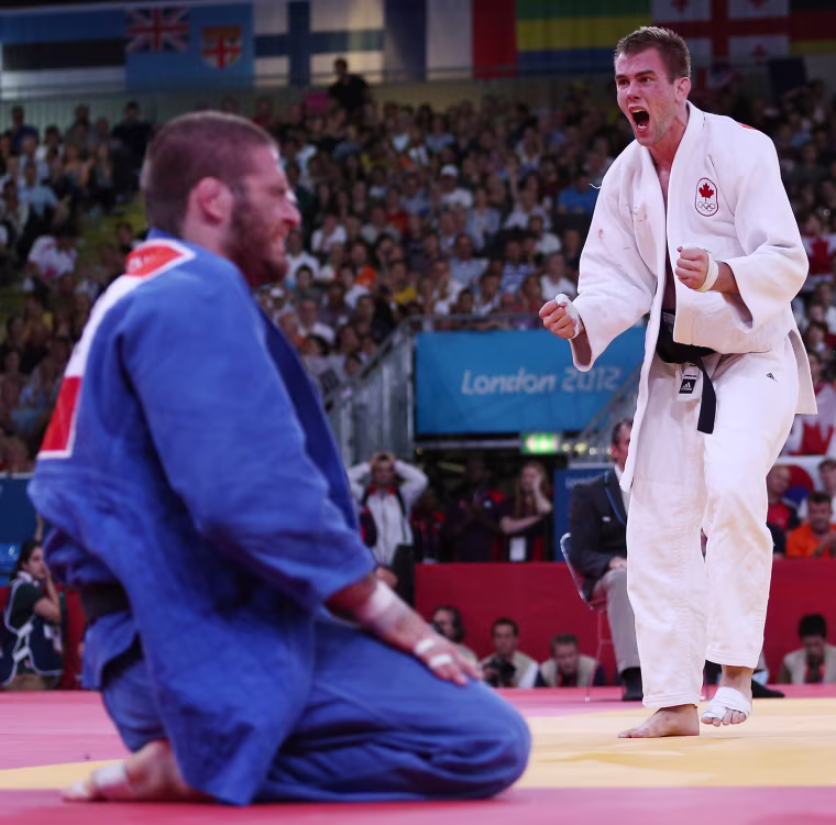 Antoine Valois-Fortier of Canada, right, reacts to defeating Travis Stevens of the U.S. in Judo on July 31.