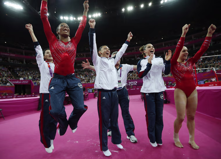 U.S. gymnasts, left to right, Gabrielle Douglas, Kyla Ross, McKayla Maroney and Jordyn Wieber celebrate as they look at the score of a teammate's performance during the Artistic Gymnastics women's team final on July 31.