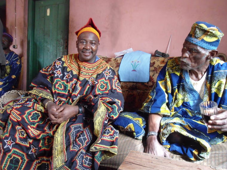 Atlanta-based family researcher William Holland sits alongside one of the Oku elders, Samuel Nshiom