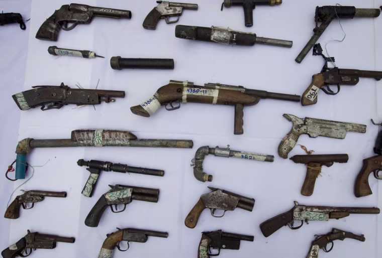 Rudimentary weapons confiscated by the police are displayed during a news conference in Caracas. Venezuela's Interior and Justice Minister Tareck El Aissami said about 1,800 firearms were seized this year in various operations in the Caracas metropolitan area as part of police efforts to combat crime.