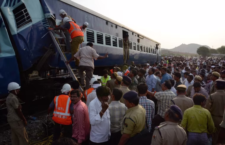 Emergency services search for injured passengers under the derailed carriages.